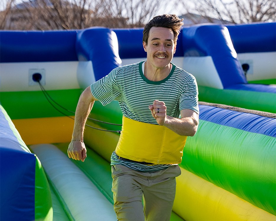 Man running in a bungee game at one of the world's largest bounce houses