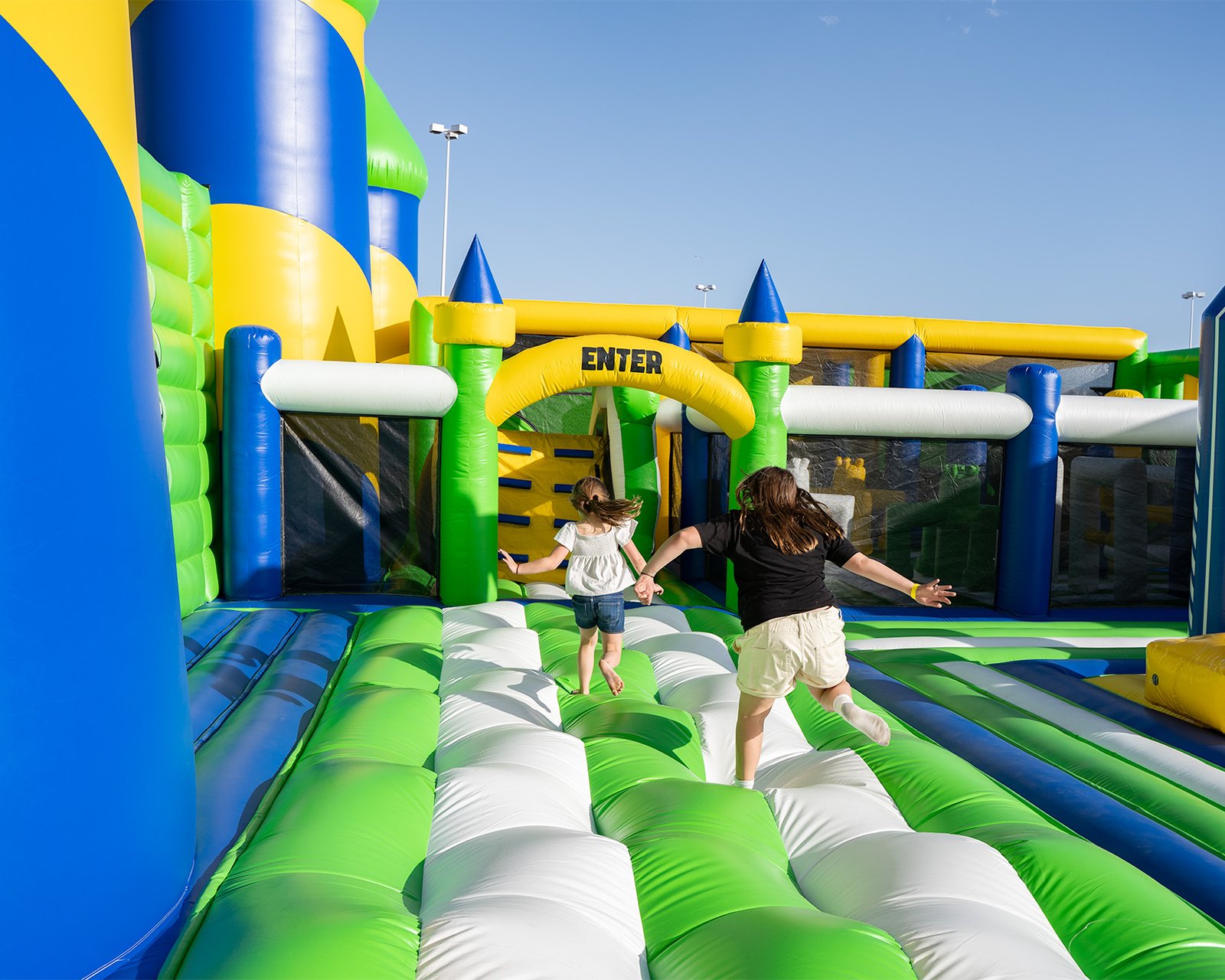 Two girls entering an obstacle course at one of the world's largest bounce houses