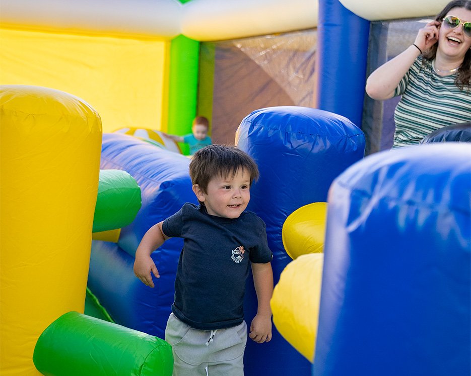 Little boy running through an obstacle course at one of the world's largest bounce houses