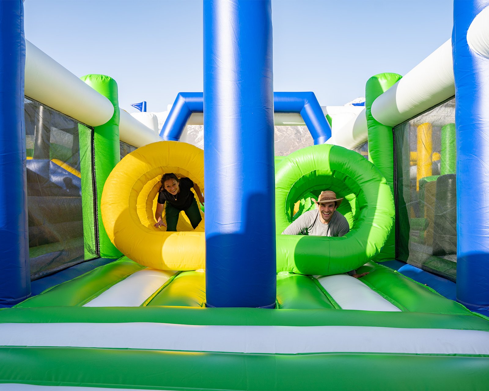 Couple crawling through obstacle course at one of the world's largest bounce houses