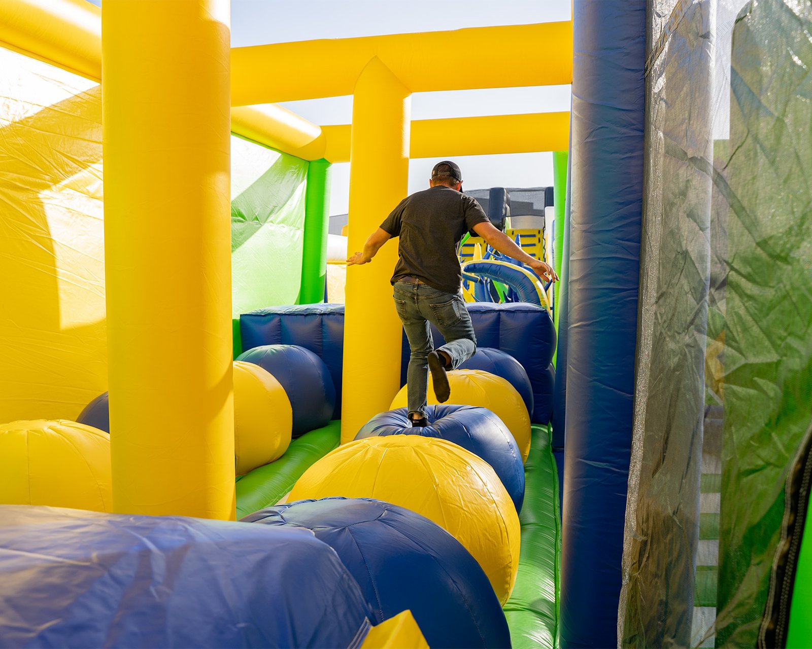 Man running through obstacle course at one of the world's largest bounce houses