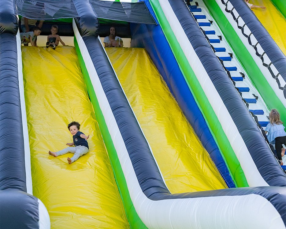 Boy sliding down inflatable slide at one of the world's largest bounce houses
