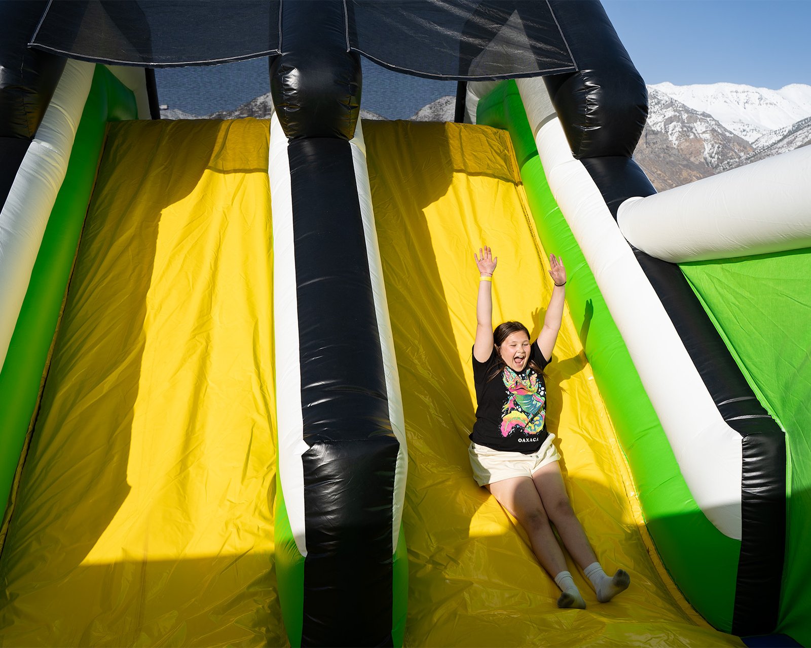Girl sliding down slide at one of the world's largest bounce houses