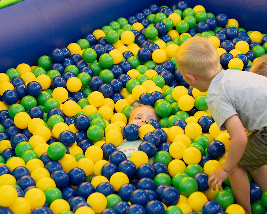 Little boys playing in a ball pit at one of the world's largest bounce houses