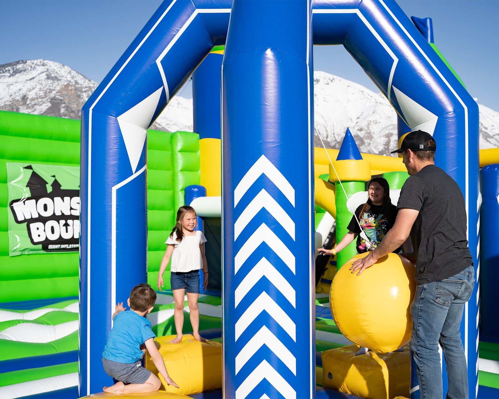 People playing a wrecking ball game at one of the world's largest bounce houses
